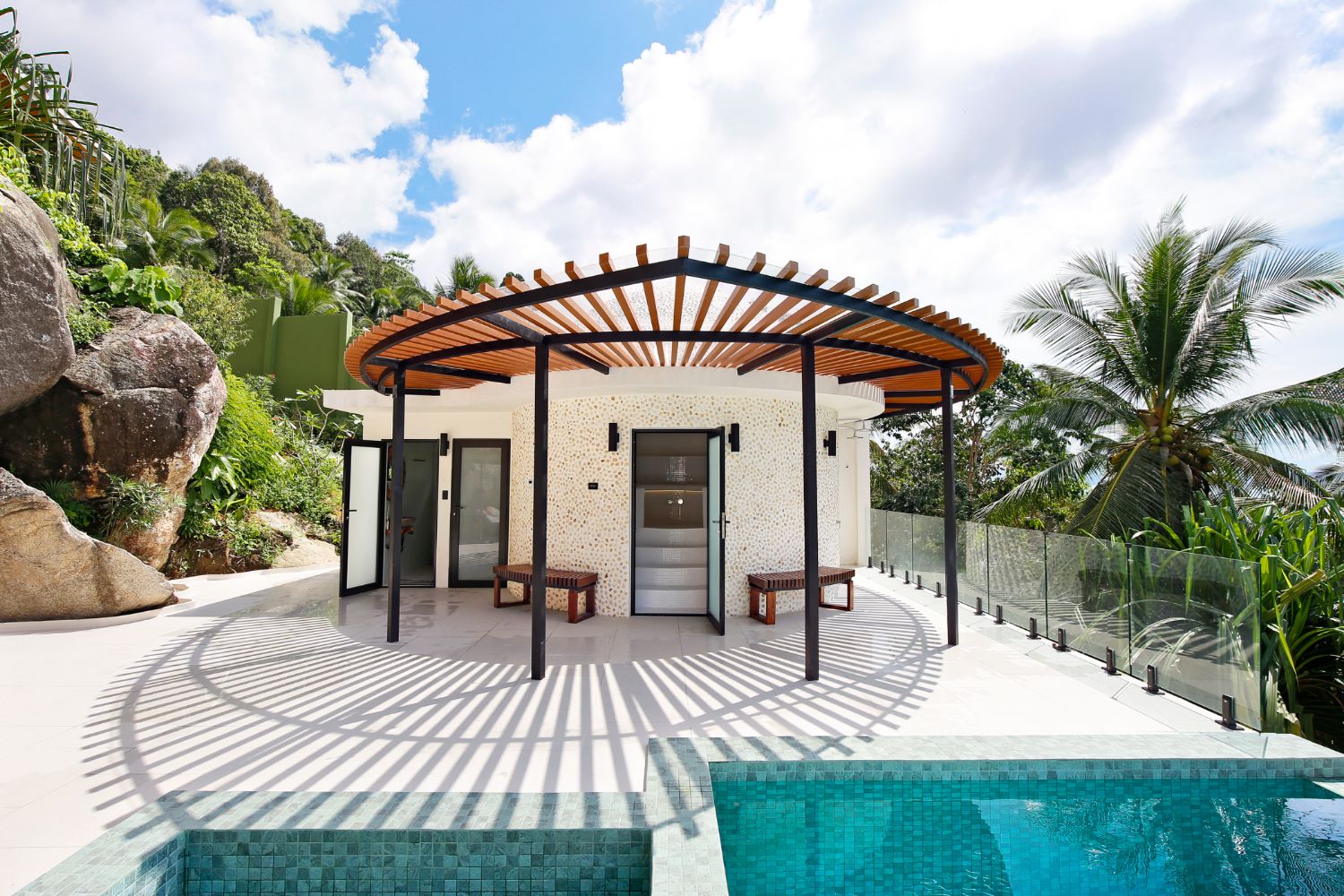 The domed steam building under its radial timber pergola at the head of the pool